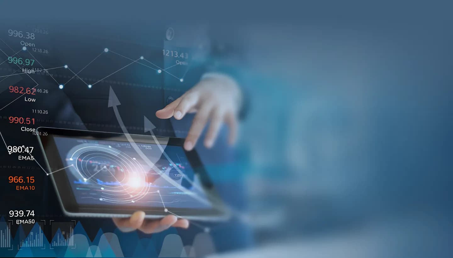 Executive holding a tablet surrounded by financial market data
