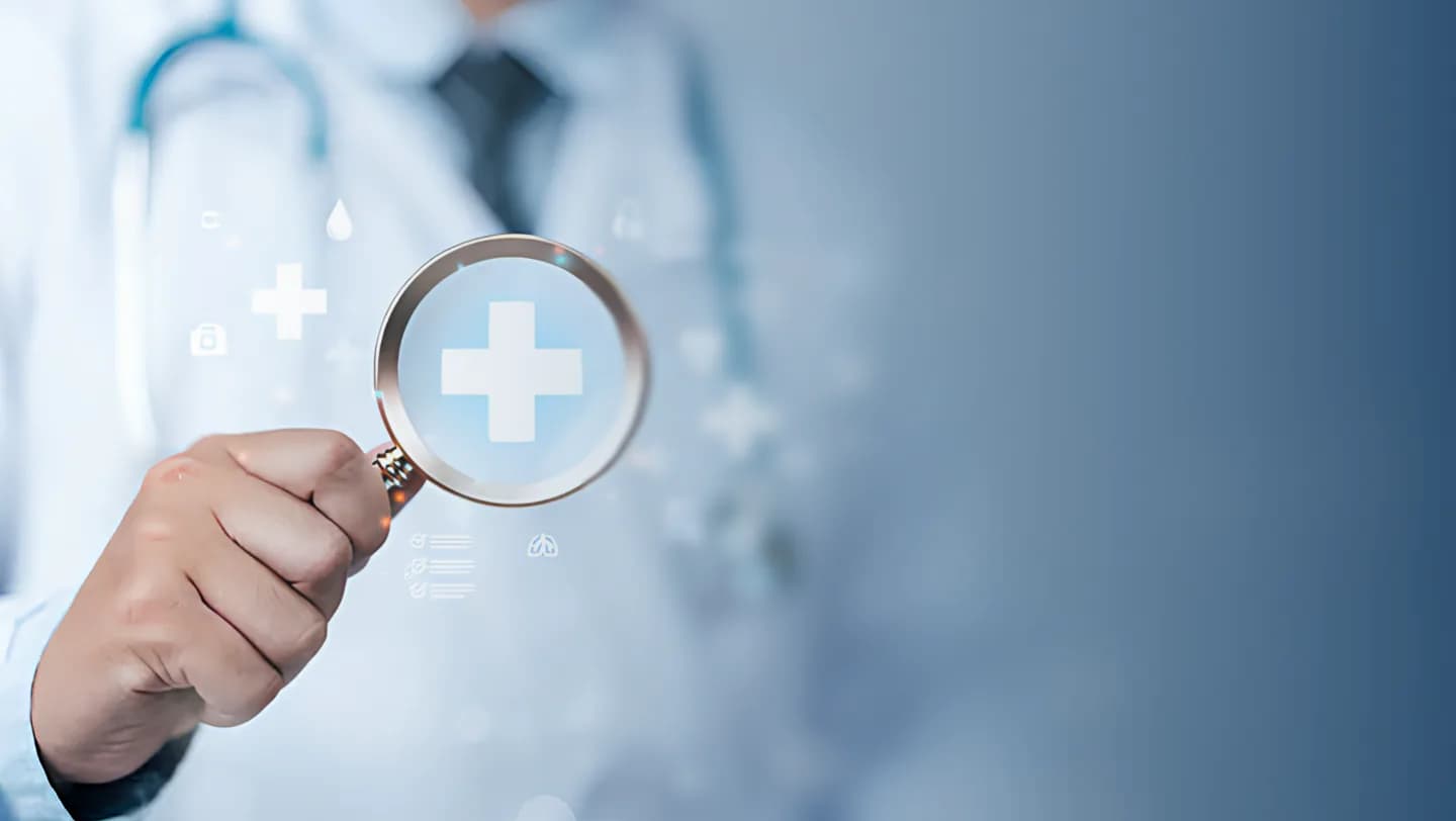 Doctor holding a magnifying glass over a medical cross